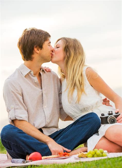 Attractive Couple On Romantic Afternoon Picnic Kissing Stock Image