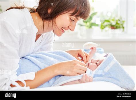 Happy Mother Is Drying Baby With A Towel After Bathing Stock Photo Alamy