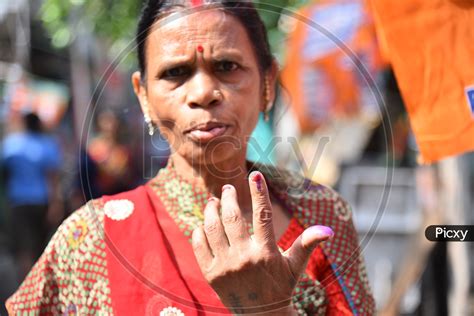 Image Of An Indian Woman Showing Inked Finger After Casting Her Vote In