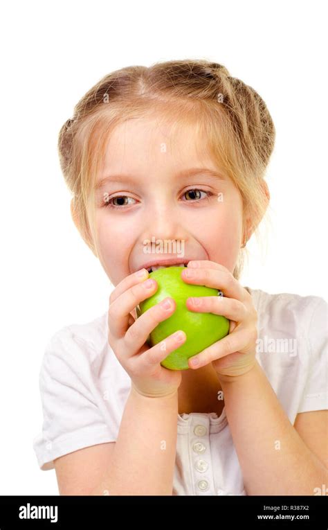 Little Girl Eating Apple Isolated On A White Background Stock Photo Alamy