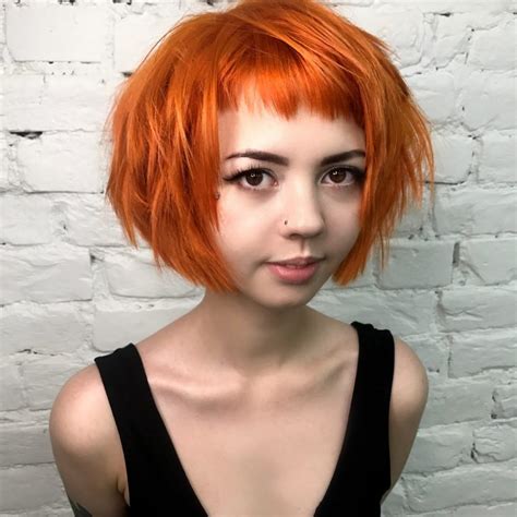 Choppy Red Graduated Bob With Fringe Bangs And Black Shadow Roots The