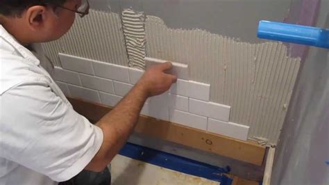 Begin applying thinset using the smooth side of the notched trowel and spread an use the notched edge of the trowel to create ridges in the layer of thinset, and lay down the tile in the exact place from which you picked it up. Subway tile shower install time lapse - YouTube