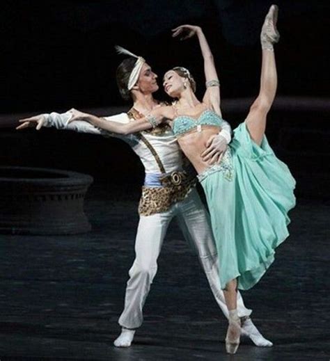 Two Ballerinas Are Performing On Stage Together