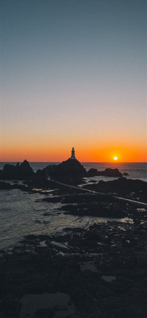 Man Standing On Rock Formation During Golden Hour Iphone X Wallpapers