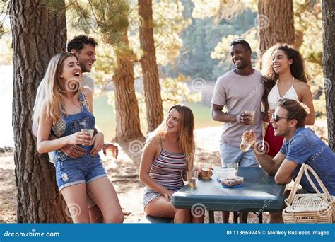 Group Of Adult Friends Hanging Out By A Lake Close Up Stock Image