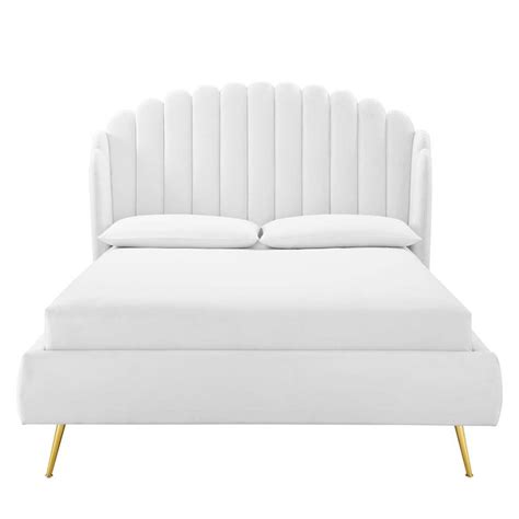 A Bed With White Sheets And Pillows On Top Of Its Headrests