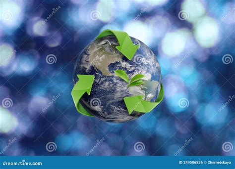 Recycling Concept Earth Planet With Green Arrows And Leaves On Blurred