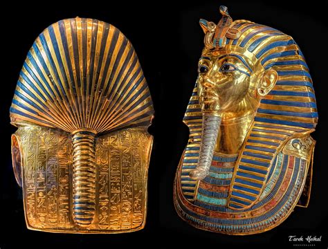 Two Gold And Blue Egyptian Masks Are Shown In Front Of A Black Background One Has An Open Mouth