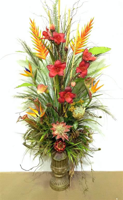 Artificial flowers are imitations of natural flowering plants used for commercial or residential decoration. Tropical arrangement designed by Arcadia Floral and Home ...