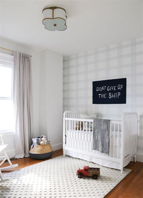 A Baby Boy Nursery With Preppy Plaid Wallpaper
