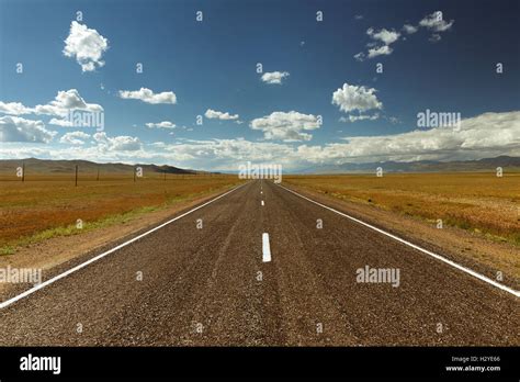Straight Road Goes To Horizon And Mountains Stock Photo Alamy