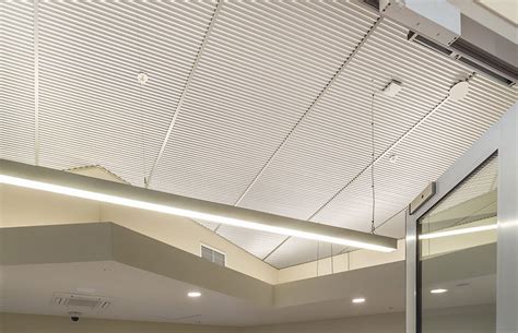 This also helps block sound transmission to other rooms. RippleTone Acoustic Metal Ceiling by Renhurst