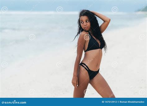Beautiful Dark Skinned Girl In Swimwear Posing On White Sand Beach
