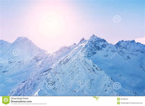 Winter Snow Covered Mountains At Sunset Stock Photo