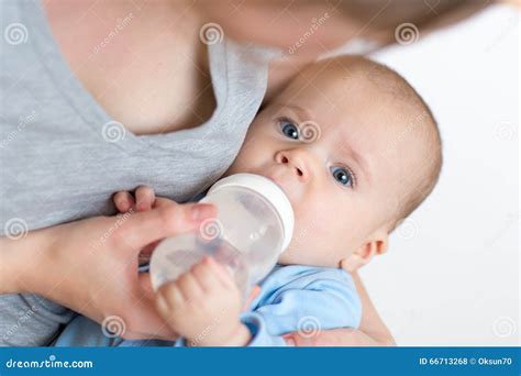 Mother Feeding Her Baby Infant From Bottle Stock Photo Image Of