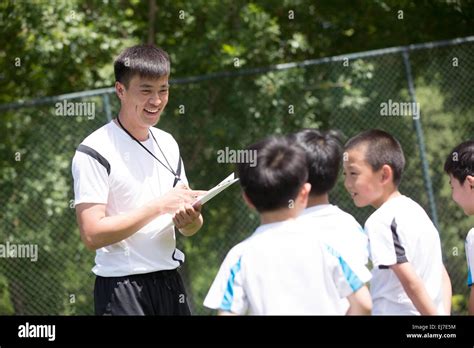 The Football Coach Was Instructing Boy Playing Skills Stock Photo Alamy