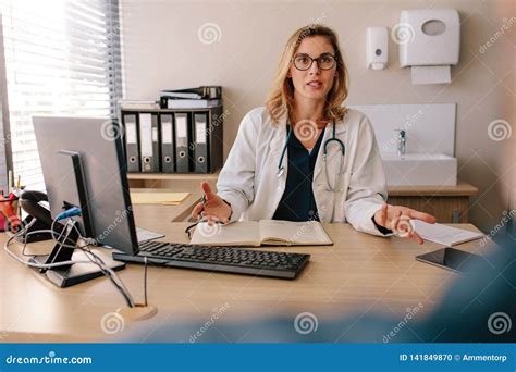 Female Doctor Consulting A Patient In Clinic Stock Photo Image Of