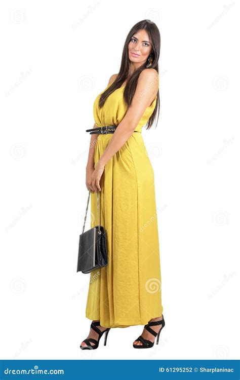 Gorgeous Beauty In Yellow Dress With Black Leather Handbag Stock Photo
