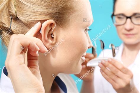 Stock Photo Hearing Aid The Doctor Assumes The Woman Hearing Aid In