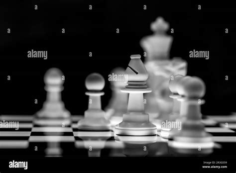 Close Up Of Chess Pieces On A Reflective Mirror Board Surface With