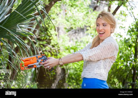 Young Woman Playing With Nerf Guns In Park In Florida Stock Photo Alamy