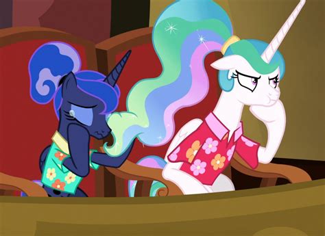 Two Ponies Are Sitting In A Chair And One Is Looking At The Other Side