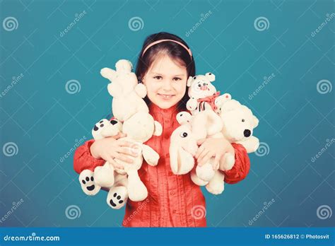 Cherishing Memories of Childhood. Small Girl Smiling Face with Toys