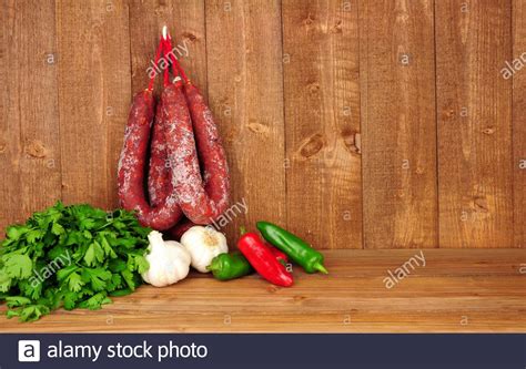 Spicy Chorizo Salami Sausages Hanging On A Rustic Wooden Background