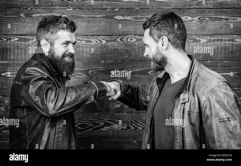 Brutal Bearded Men Wear Leather Jackets Shaking Hands Strong Handshake Friendship Of Brutal