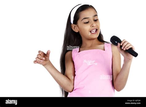 A Young Girl Holding A Mic Stock Photo Alamy