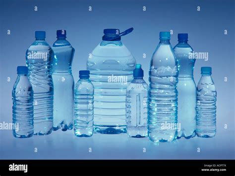 9 Plastic Bottles Of Water With Different Size Grey Background Stock