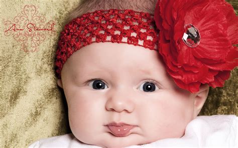 Wallpaper Of Super Baby A Cute Baby With A Big Red Flower On Th Head
