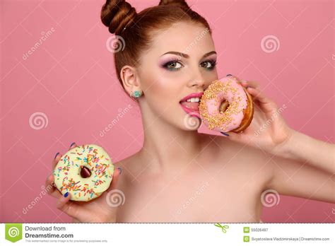Young Girl With Dark Hair And Bright Makeup Holding Sweet Donuts Stock