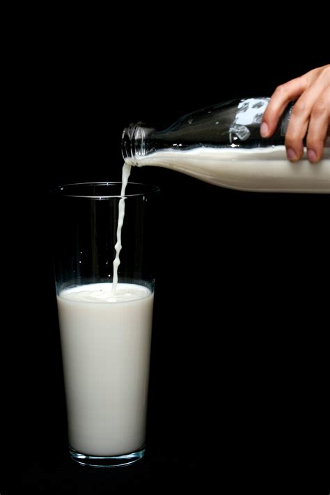 Person Pouring Milk In Highball Glass 1435706 Holy Cow Delivery