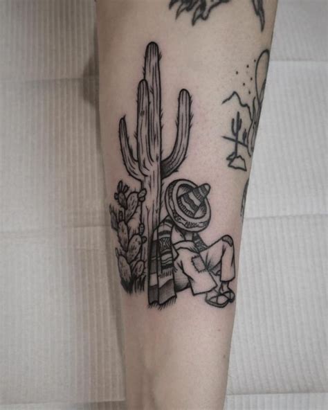 Cactus And Sleeping Mexican Guy With A Sombrero Inked On The Forearm