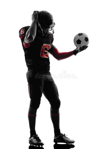 American Football Player Holding Soccer Ball Confused Silhouett Stock