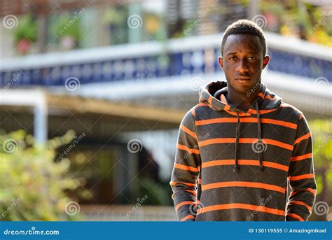 Portrait Of Young African Man Outdoors Wearing Hoodie Stock Image