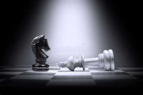 White King Chess Piece Defeating By Black Knight Chess Piece Stock