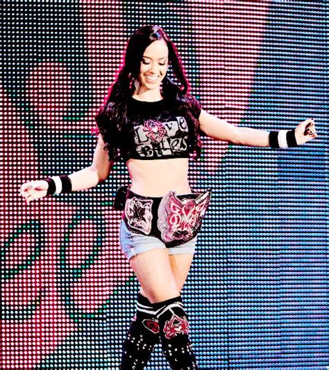 A Female Wrestler Is Posing On The Stage