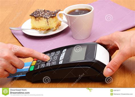 A man and a woman behind a coffee shop counter looking at a tablet to learn about the best business credit cards for business owners and. Use Payment Terminal For Paying For Cheesecake And Coffee In Cafe, Finance Concept Stock Image ...