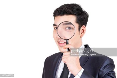 Man Looking Through Magnifying Glass Photos And Premium High Res
