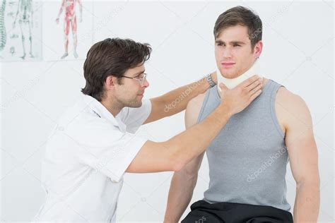 Male Doctor Examining A Patients Neck Stock Photo By ©lightwavemedia