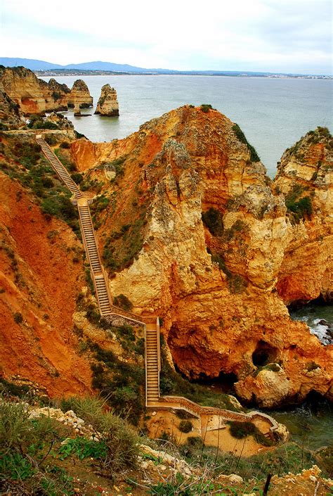 Wooden stairs, about 200 degrees, lead to them. Stairs to Praia do Camilo, Lagos / Portugal (by... - It's ...
