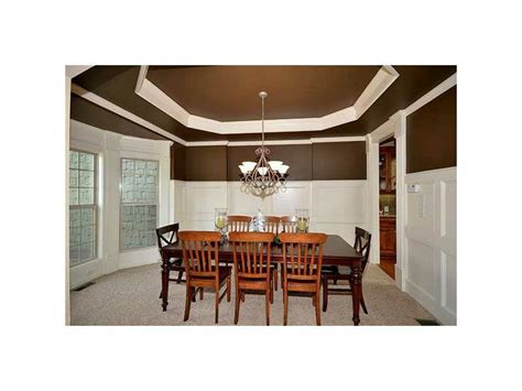 Fabulous Dining Room With A Trey Ceiling And Designer Wainscoting