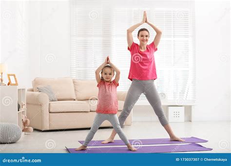 Young Mother With Little Daughter Practicing Yoga Stock Image Image