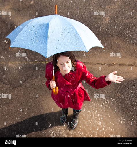 Young Woman Standing In Rain Holding Umbrella Stock Photo Alamy