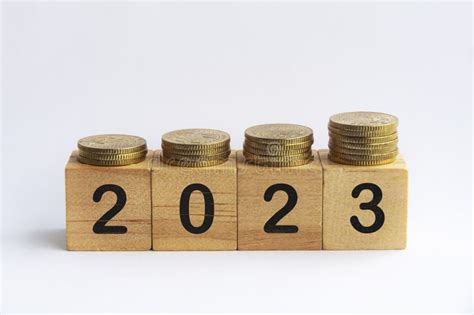 New Year 2023 Text On Wooden Blocks With Gold Coins On Top On White