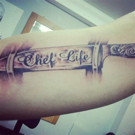 Chef knife and red flowers traditional tattoo on forearm. 14 Amazingly Creative Chef Tattoos