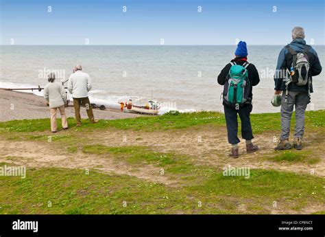 Walkers Enjoying A Stroll Along The North Norfolk Coastal Path East