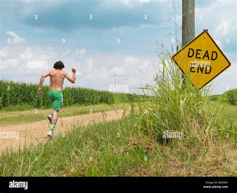 Man Running Along Dirt Road Stock Photo Alamy